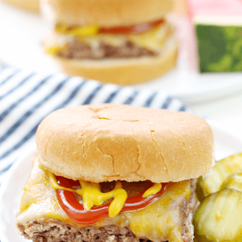 Easy Beef Slider on a white plate with sliced pickles.