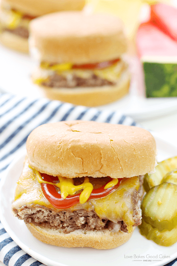 Easy Beef Slider on a white plate with sliced pickles.