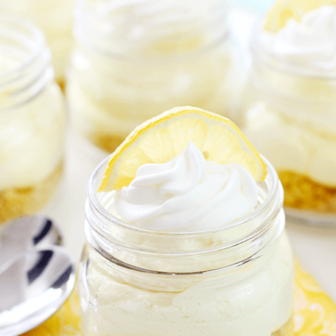 No-Bake Lemon Cheesecake in a jar with a slice of lemon.