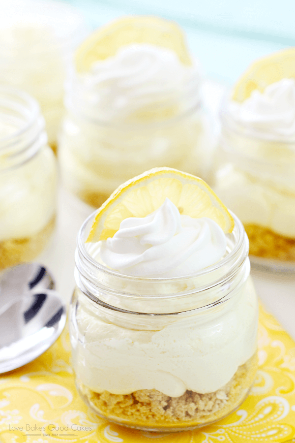 No-Bake Lemon Cheesecake in a jar with a slice of lemon.