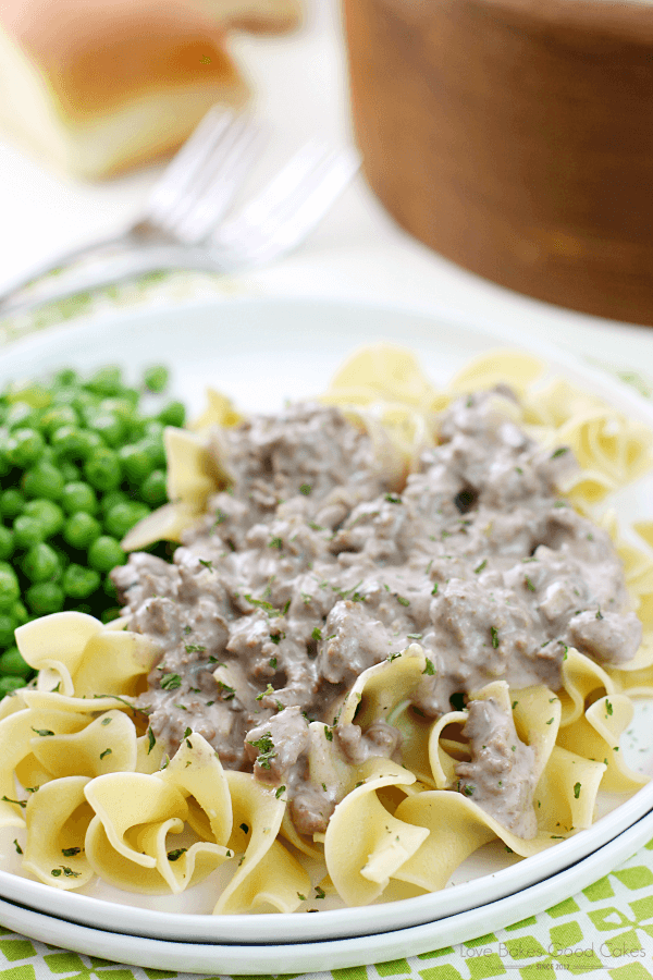 Hamburger Stroganoff on a white plate with peas.