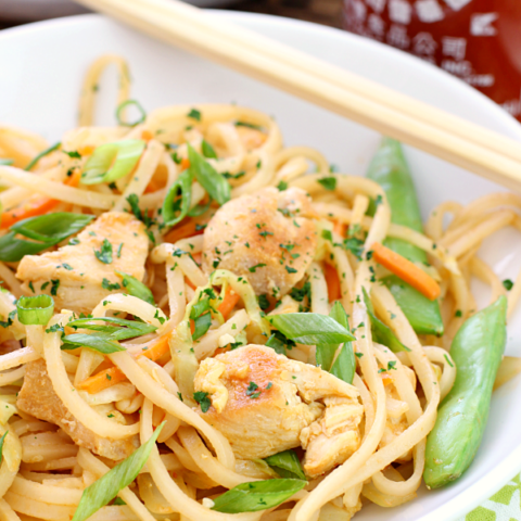 Dragon Noodles in a white bowl with chop sticks.