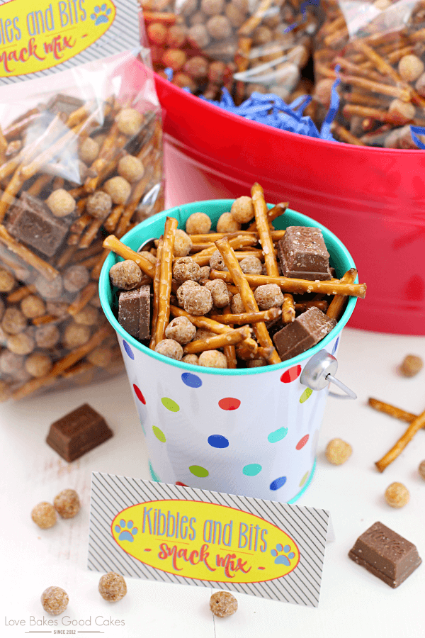 Pretzel snack mix in a metal bucket and in a bag.