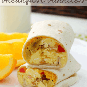 Bacon & Egg Breakfast Burritos stacked on a white plate.