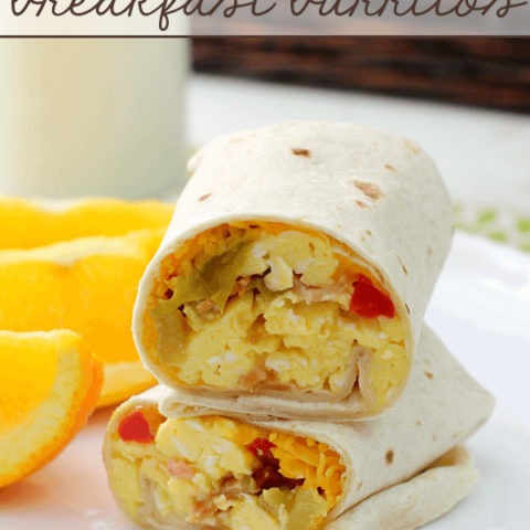 Bacon & Egg Breakfast Burritos stacked on a white plate.