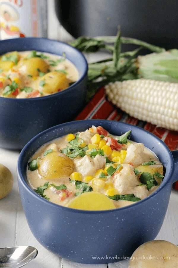 Mexican Chicken & Corn Chowder in two bowls with a spoon.