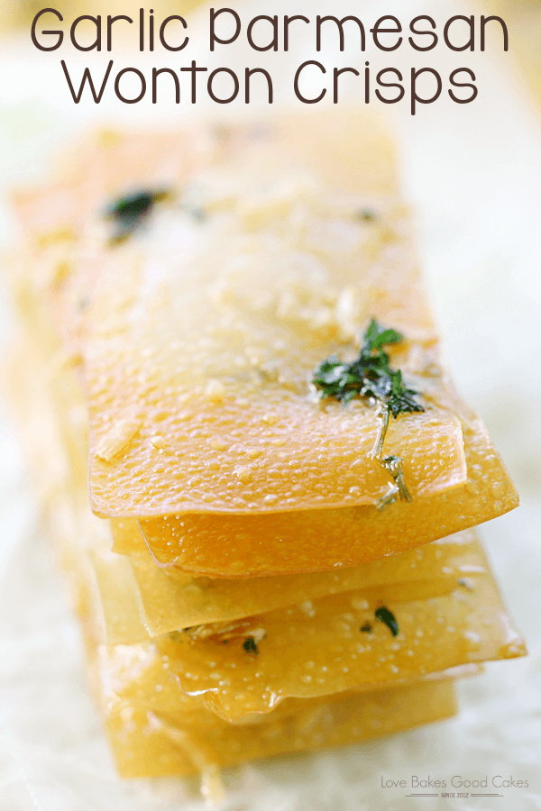 Garlic Parmesan Wonton Crisps stacked up on a piece of wax paper.