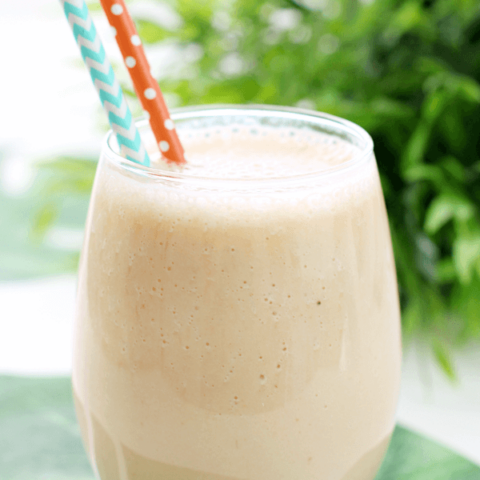 Jungle Cooler in a glass with two straws.