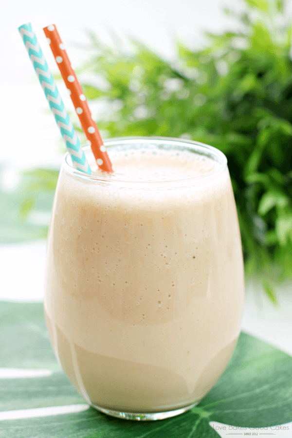 Jungle Cooler in a glass with two straws.