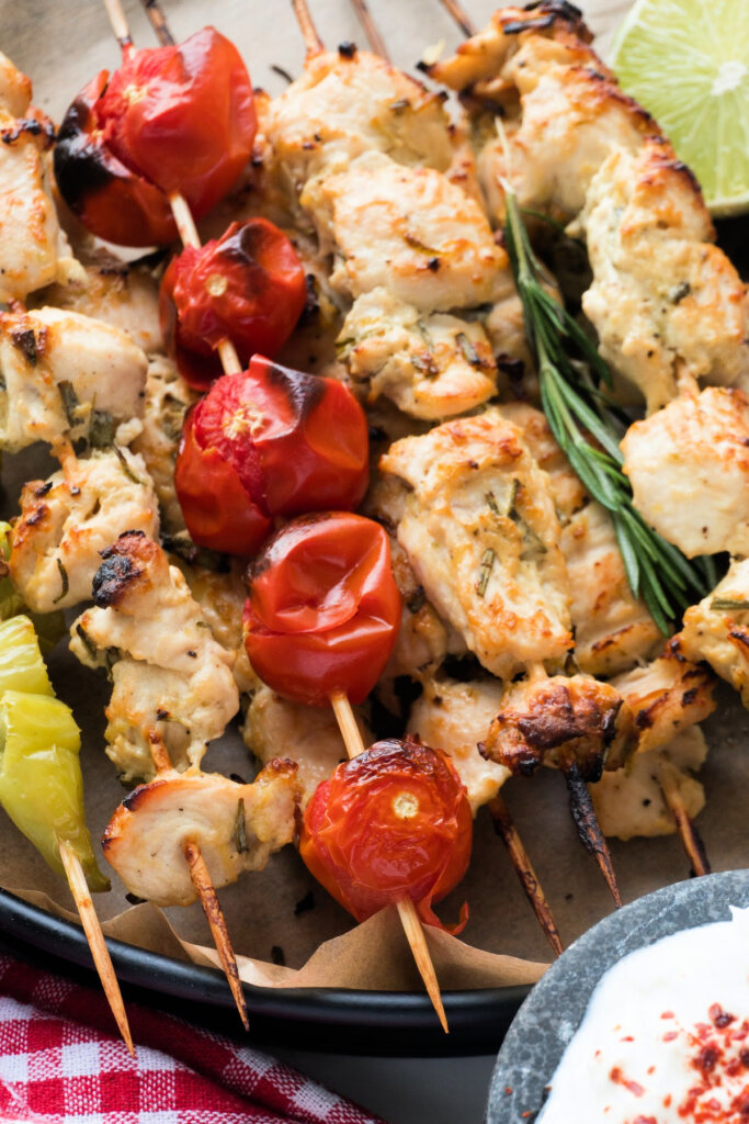 chicken skewers stacked on serving tray