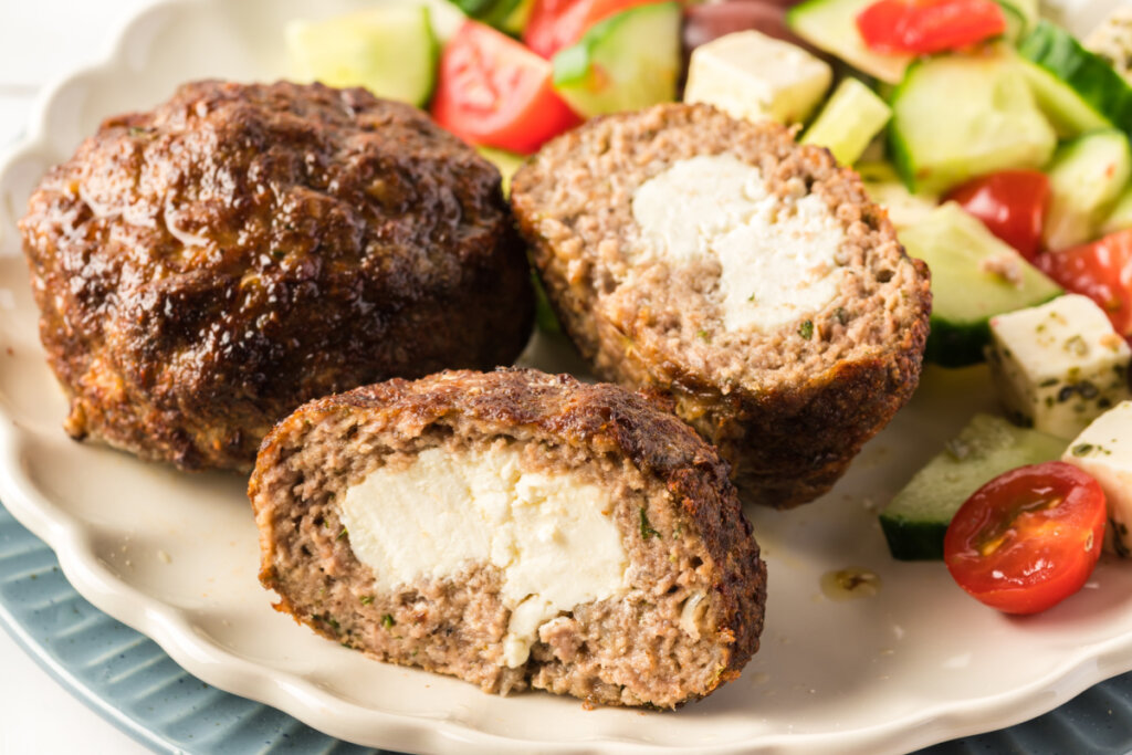 bifteki cut in half to show the feta cheese inside