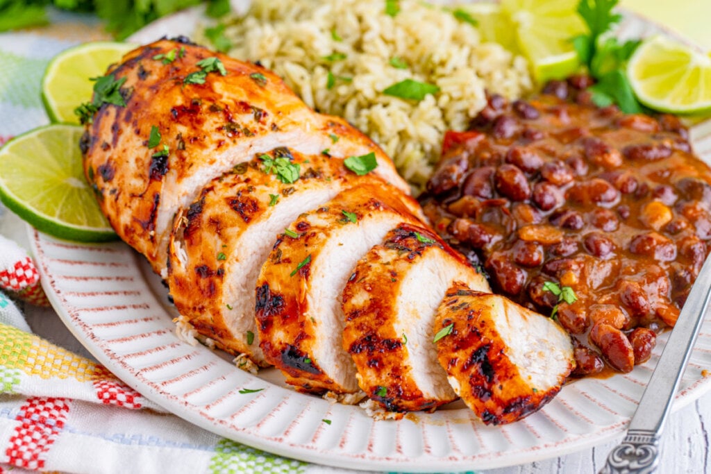 cooked meat plated with rice and beans