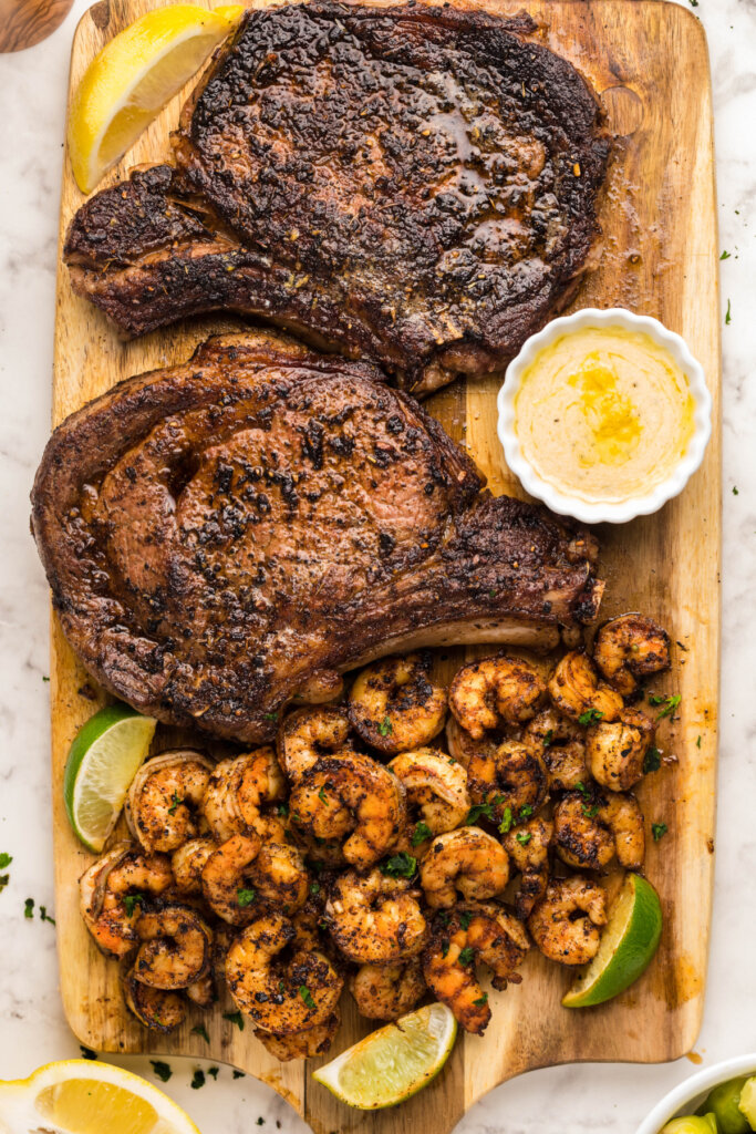 blackened steak and shrimp on wooden cutting board