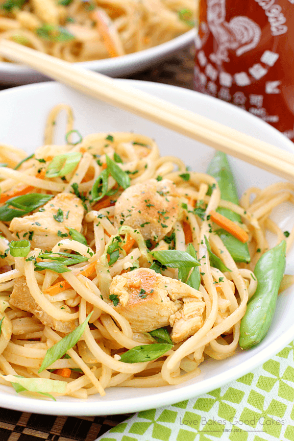 Dragon Noodles in a white bowl with chop sticks.