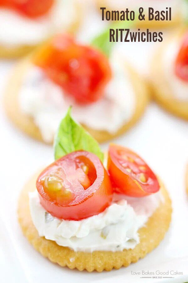 Ritz crackers with tomatoes and basil.