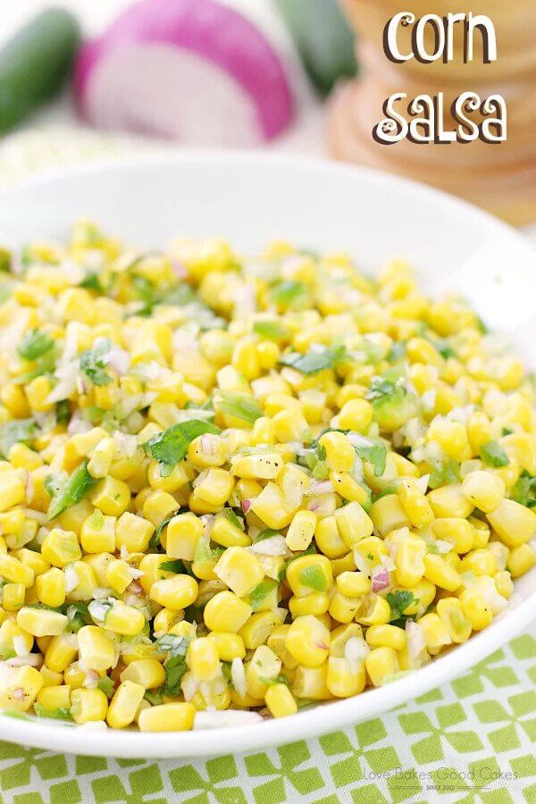 Corn with diced onions in a white bowl.