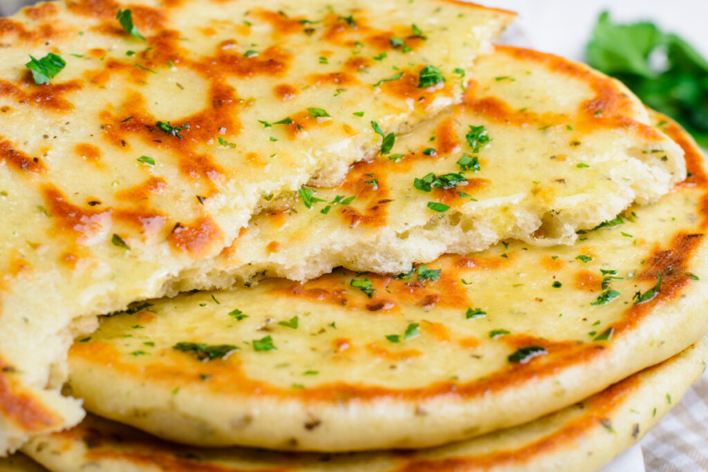 torn flatbread showing the fluffy inside