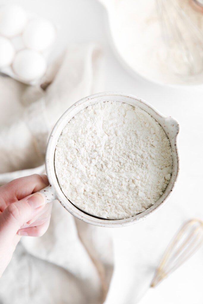 hand holding a bowl with substitute for cake flour