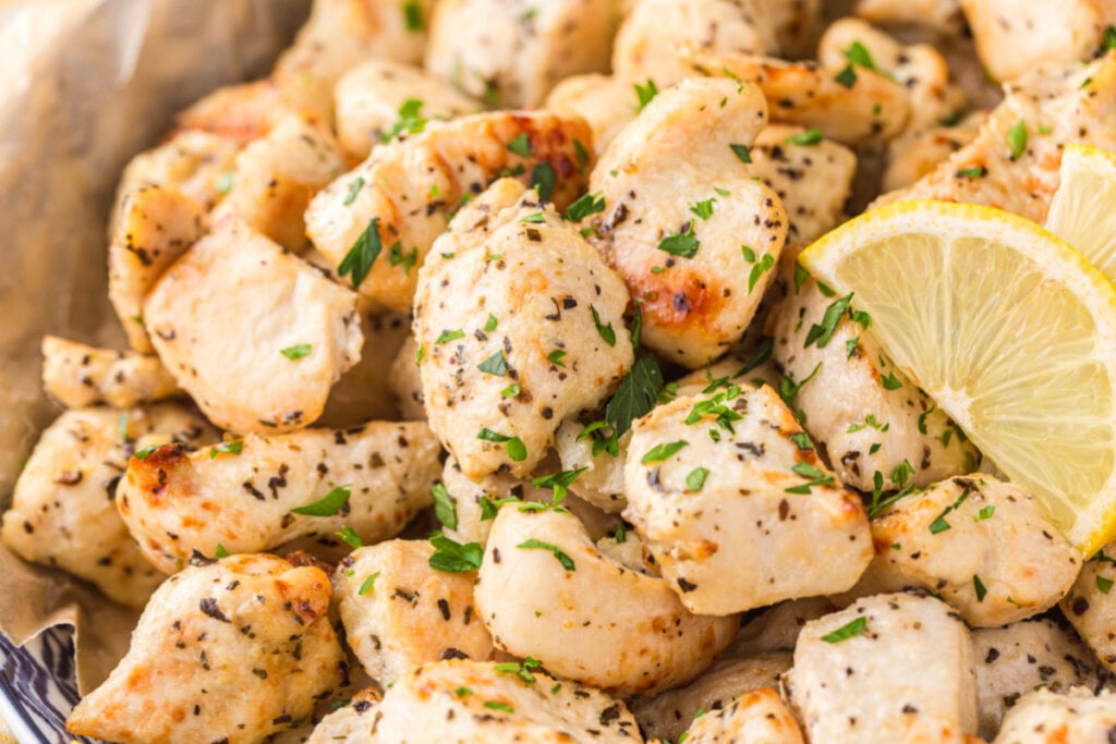 cooked lemon chicken bites with a lemon slice