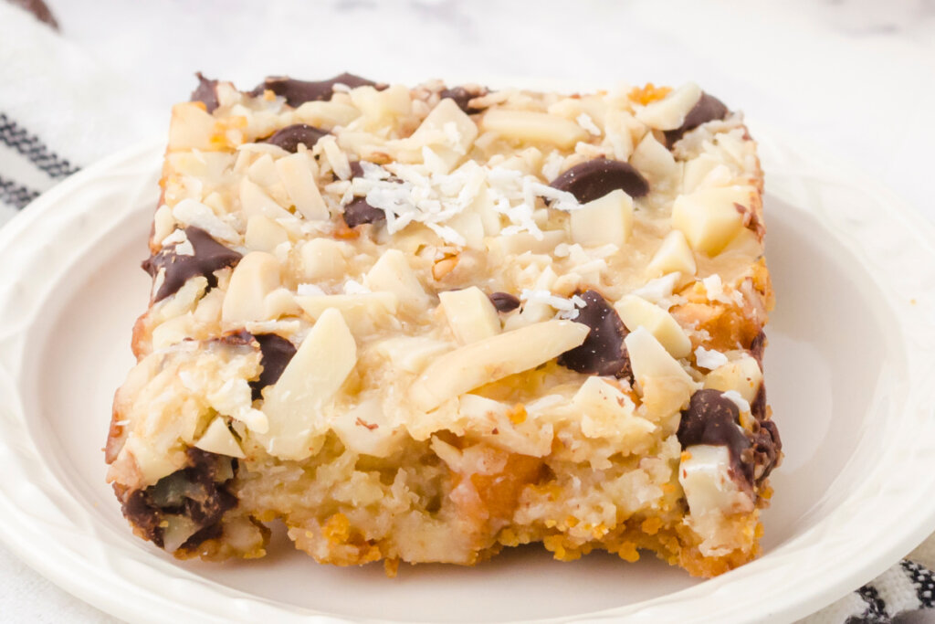 one magic cookie bar on white plate