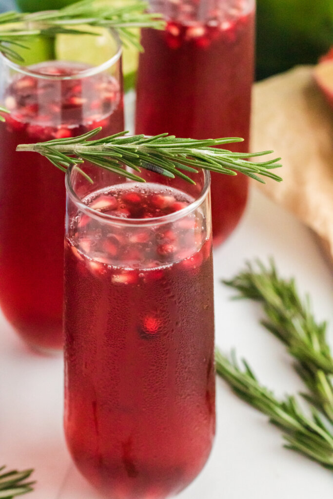 pomegranate mimosa garnished with rosemary