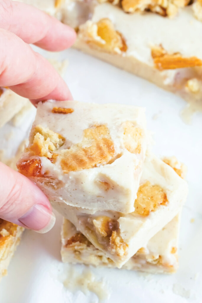 hand holding a square of apple pie fudge