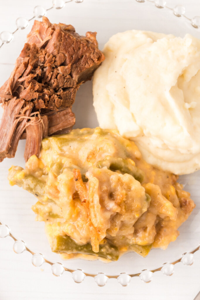 green bean casserole on plate with mashed potatoes and pot roast