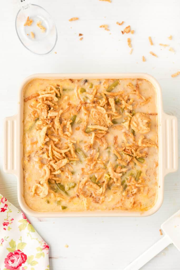 Classic green bean casserole topped with crispy fried onions and ready for the final few minutes of baking