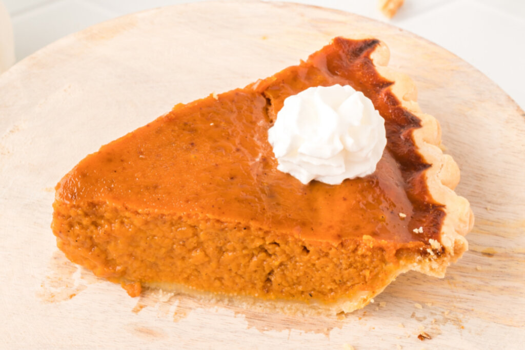 slice of pumpkin pie with a dollop of whipped cream