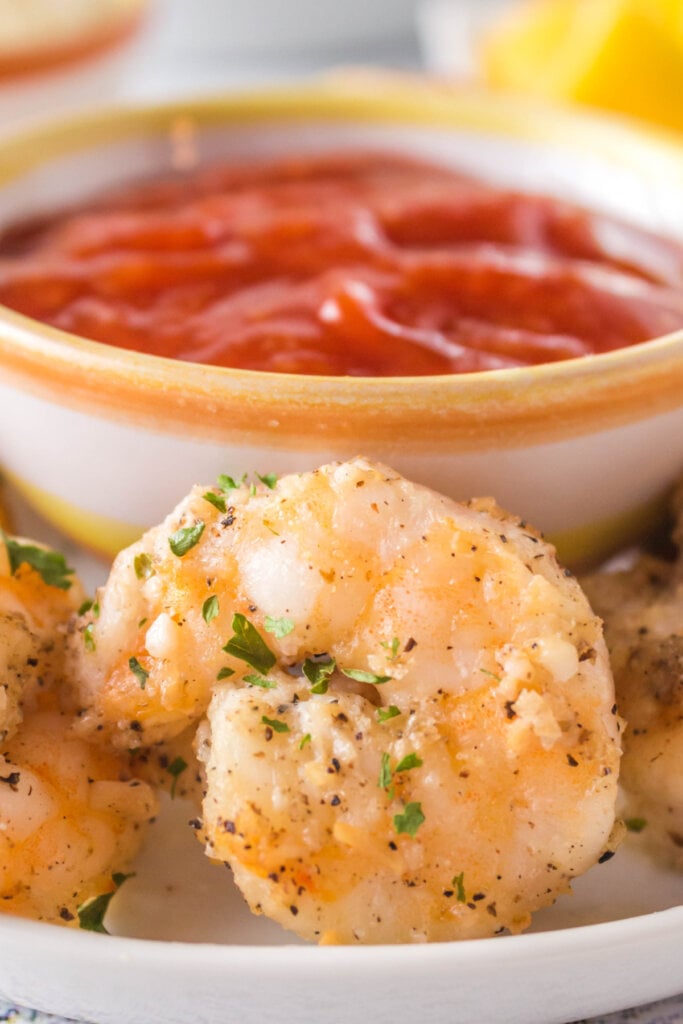 air fryer shrimp in front of small bowl of sauce
