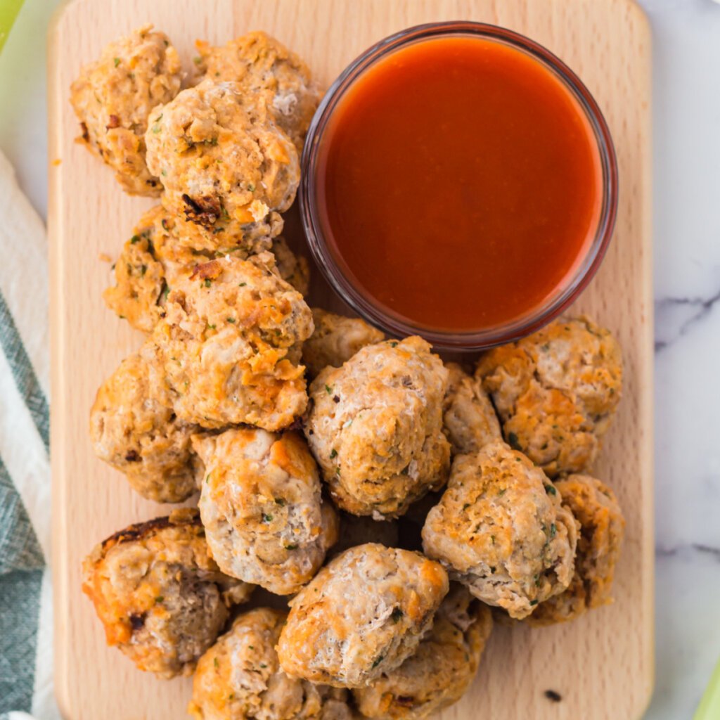buffalo chicken meatballs with sauce on wooden board
