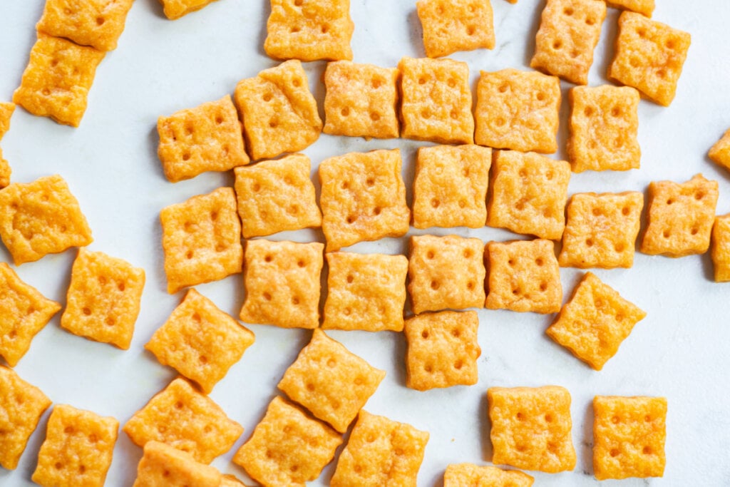 cheese crackers scattered on white background