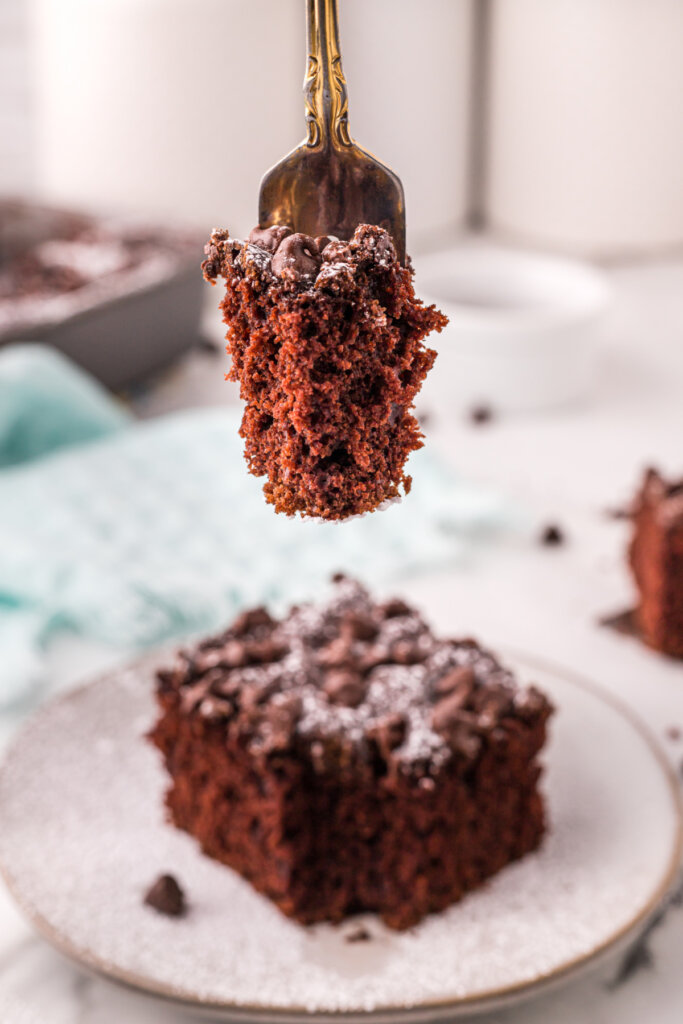 bite of chocolate cake on fork over cake slice