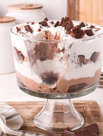 brownie trifle dessert with a scoop out to show the layers