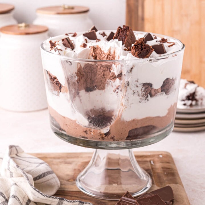brownie trifle dessert with a scoop out to show the layers