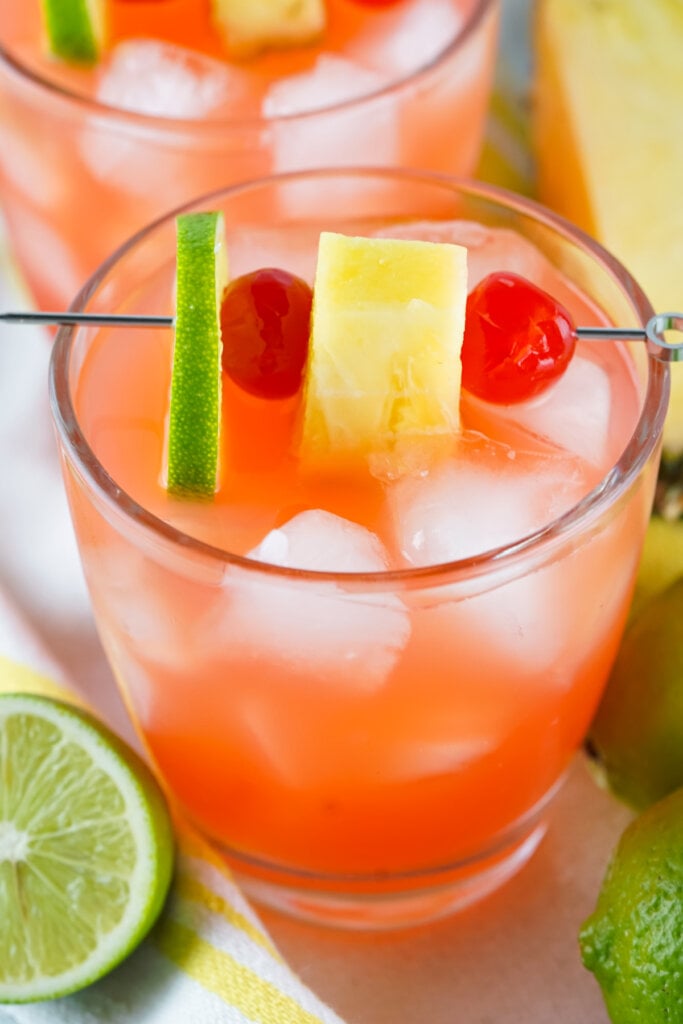 rum punch garnished with lime cherries and pineapple