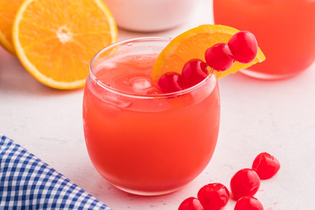 shirley temple punch mocktail garnished with cherries and orange slice