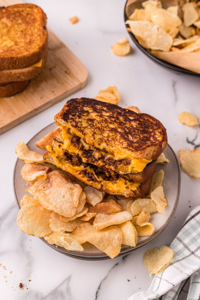 sloppy joe grilled cheese on plate with potato chips