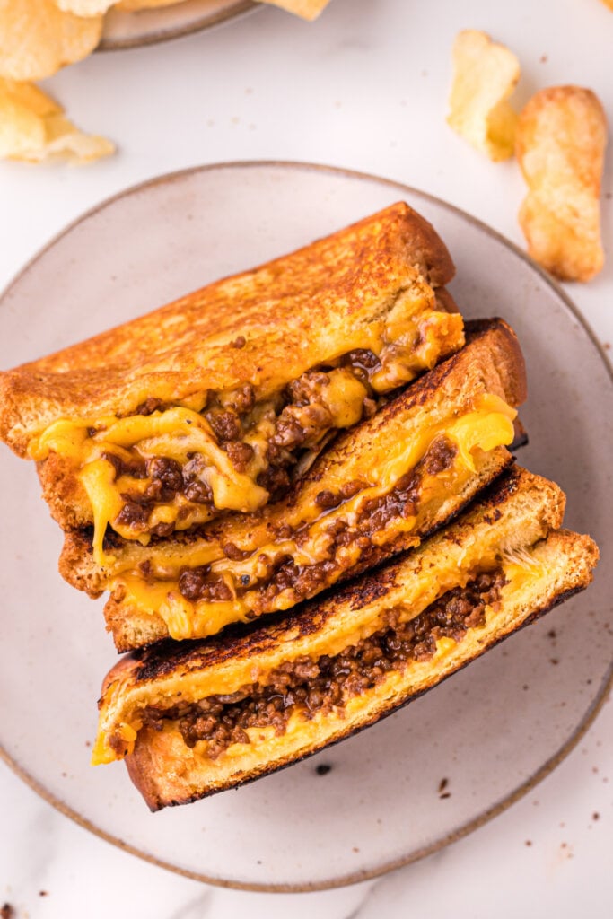 plate with three halves of sloppy joe grilled cheese