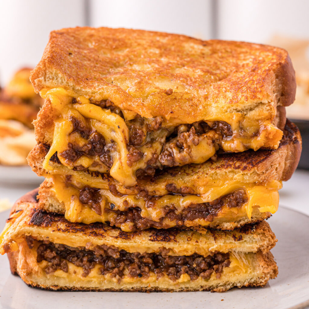 sloppy joe grilled cheese halves stacked on each other