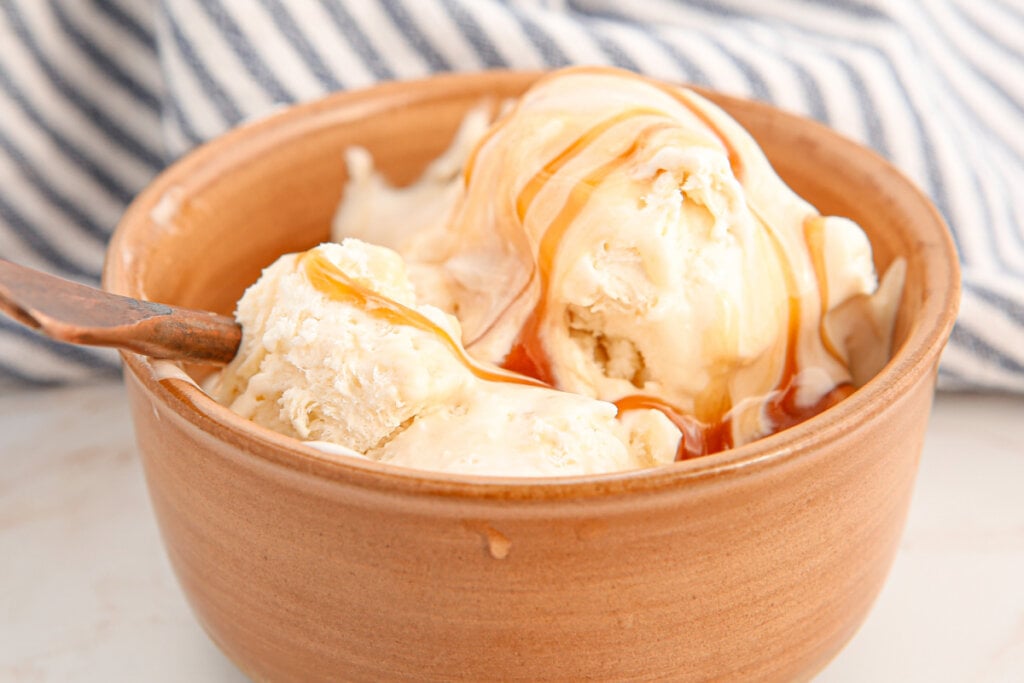 salted caramel oce cream in bowl with spoon