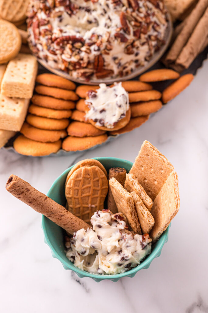 bowl with chocolate chip cheese ball scoop and assorted cookies