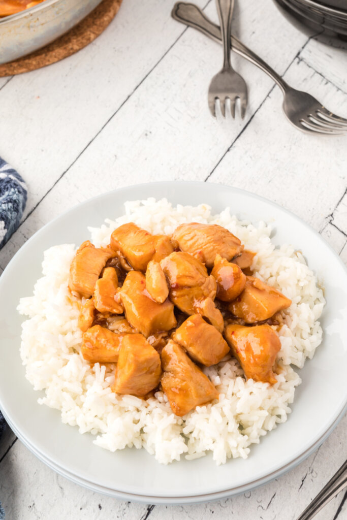 bourbon chicken over rice on plate