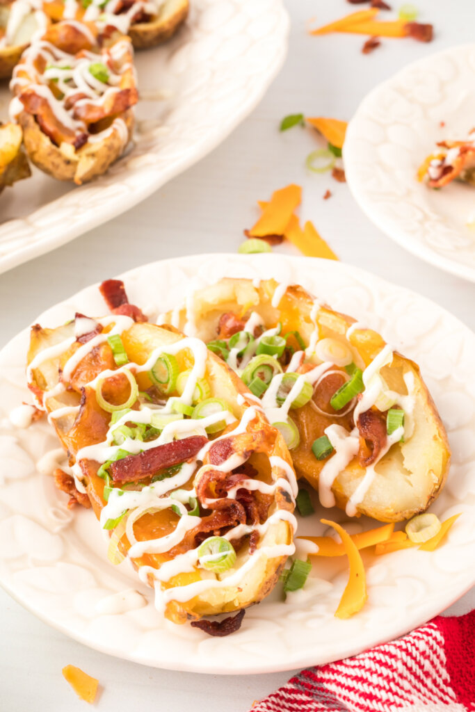two loaded potato skins on plate