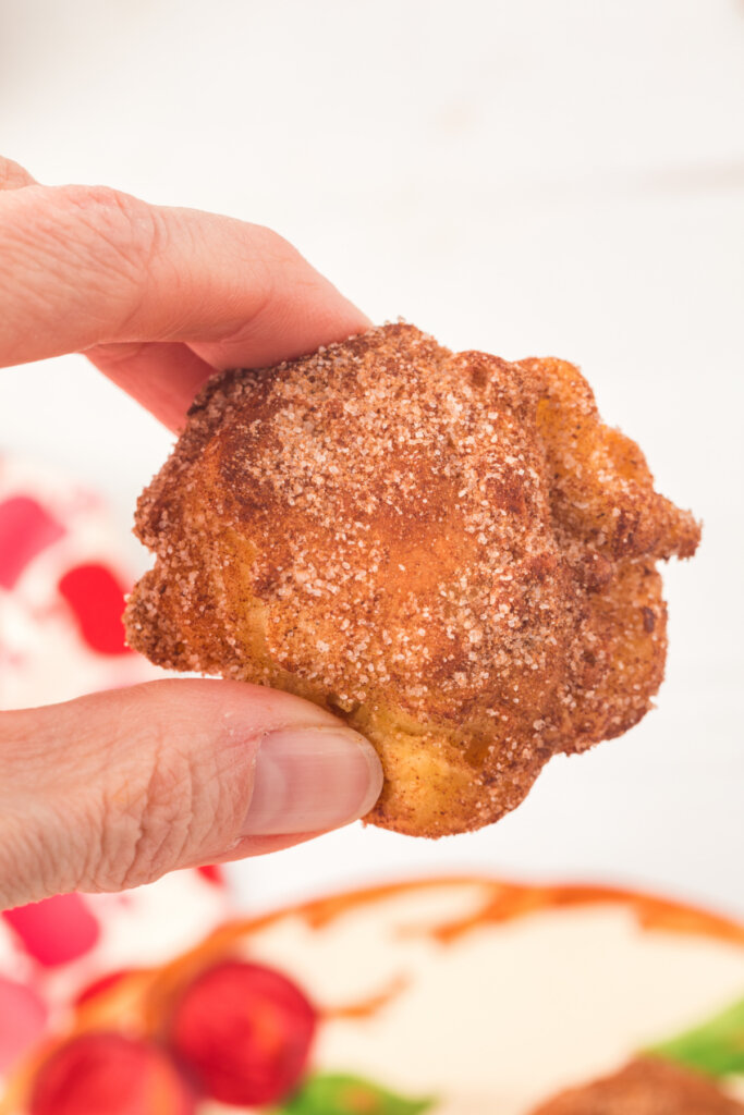 hand holding an apple fritter