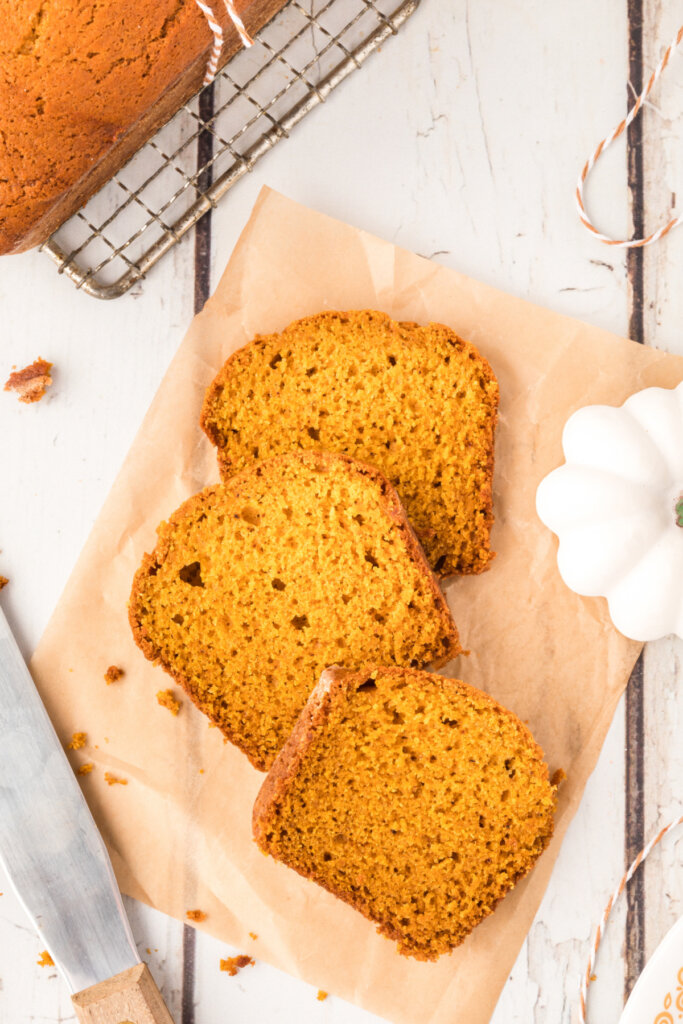 looking down onto three slices of pumpkin bread