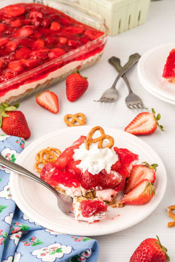 strawberry pretzel salad on plate with bite on fork