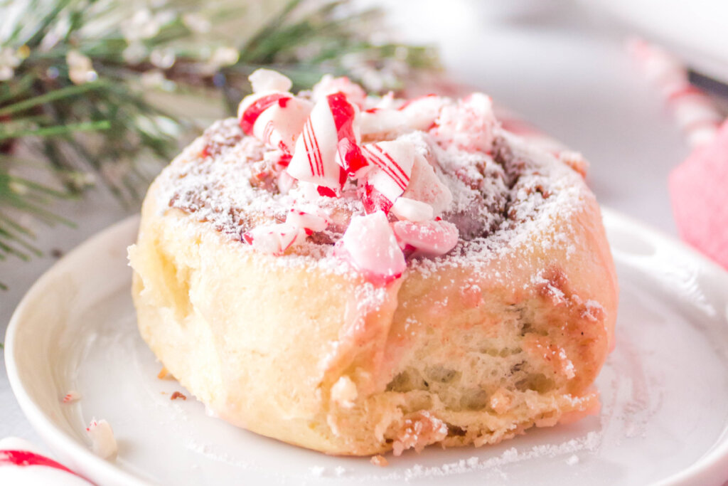 candy cane cinnamon roll on white plate
