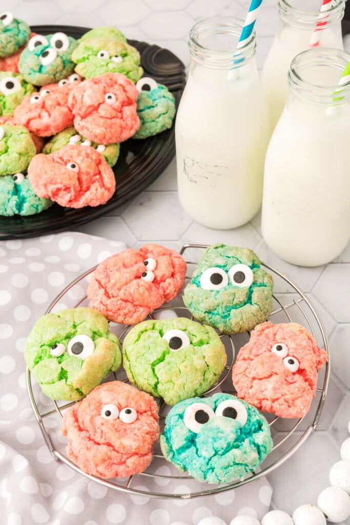 halloween cookies on cooling rack with milk bottles next to it