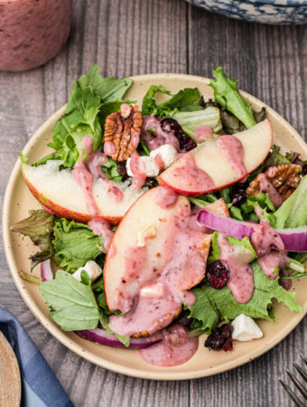 thanksgiving salad on plate with cranberry vinaigrette dressing